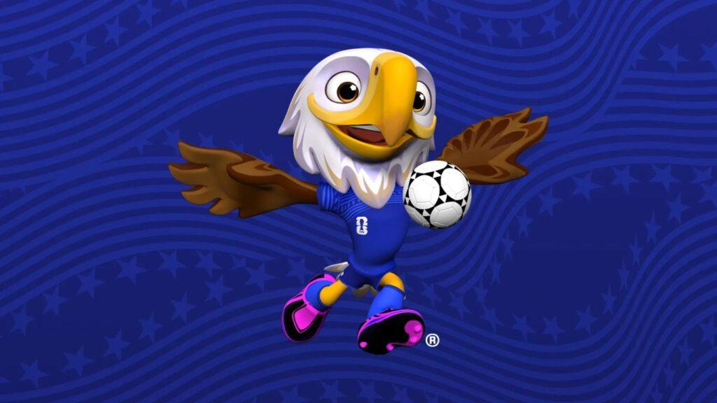 Clutch, mascota oficial del Mundial de la FIFA, México, EE.UU., Canadá 2026, que representa un águila calva estadounidense antropomórfica y caricaturizada digitalmente, con las alas desplegadas. Lleva un equipamiento color azul oscuro, con detalles rosas en los botines, y está en posición de bajar con el pecho el balón que la acompaña.